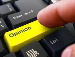 Finger Presses Yellow Button Opinion on Black Keyboard Background. Closeup View. Selective Focus.