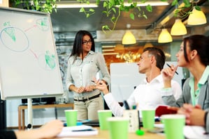 Businessperson explaining graphs to colleagues