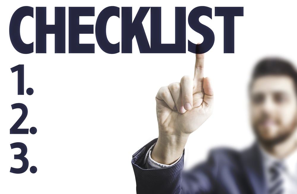 Business person pointing to the text: Checklist