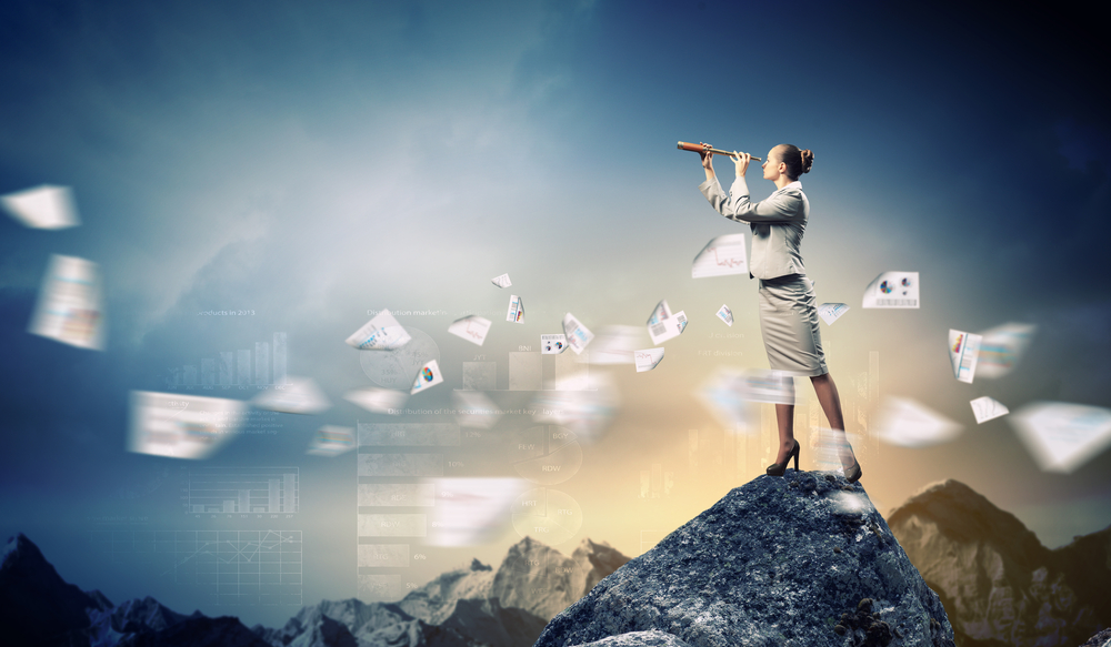 Image of businessperson looking in telescope standing on a rock